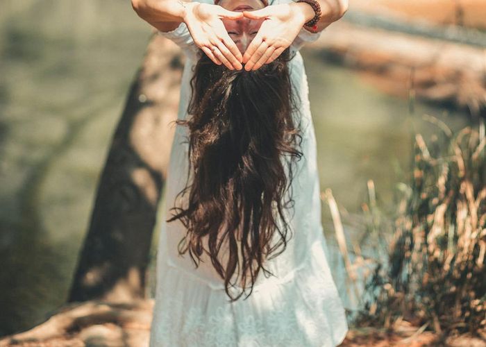 Person meditating peacefully in a bright, minimalist environment.
